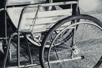 Fototapeta na wymiar Closeup Part of Wheelchair Vintage Tone for Realize Danger of Accident concept background.