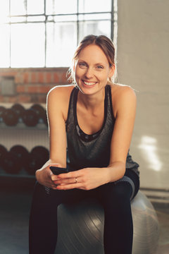 Smiling active young woman in a gym