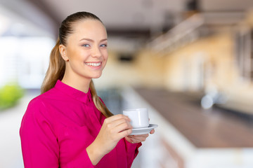 Beautiful and smiling woman with a cup of coffee