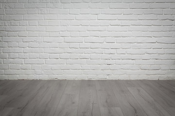 Old white brick wall and wood floor background