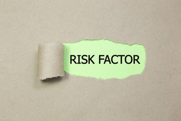 The text RISK FACTOR appearing behind torn paper