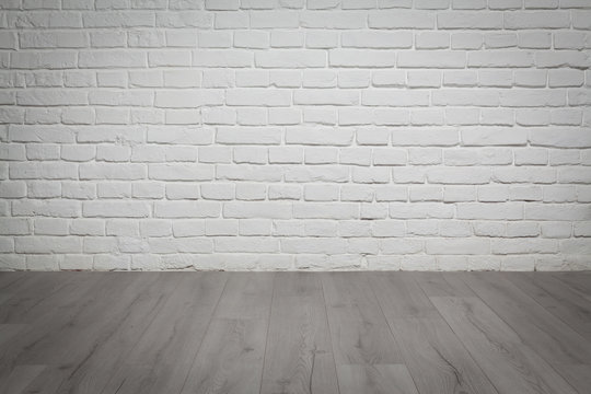 Old white brick wall and wood floor background