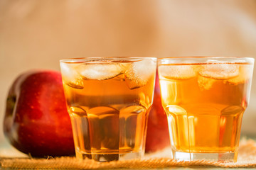 Fresh apple juice or cider in glasses on table
