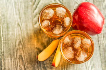 Fresh apple juice or cider in glasses on table