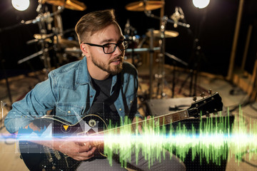 musician playing guitar at studio rehearsal