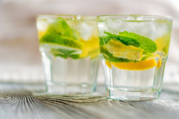 Lemonade or mojito cocktail with lemon and mint