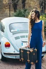 beautiful woman with suitcase and car