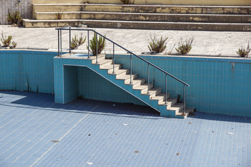A swimming pool empties and damage at the end of tourist season.