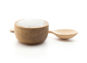 Sea salt in a wooden bowl with a spoon isolated on white background.