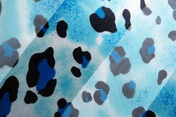 blue fabric soft silk close-up fod for design background blue scarf with black pattern spots on...