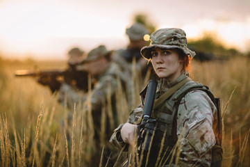 Rangers shooting with his weapon, rifle at sunset. War, army, military concept.