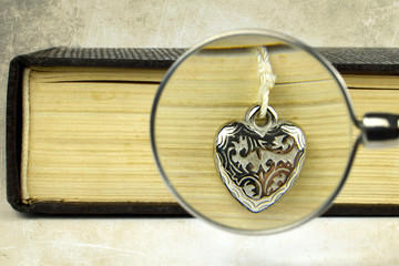 Valentines Day gift. Close up of engraved silver heart pendant 
