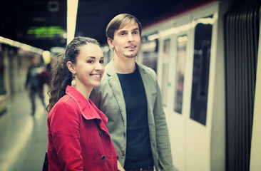 Young couple standing at underground station