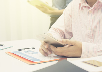 business man Using Hands Modern Smartphone. are searching for marketing information for the company's divisions to direct their public relations through social media.Teamwork Concept.People Working 