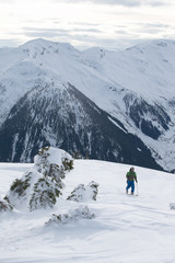 Young man ski touring in the mountains