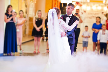 Beautiful wedding couple danicng in the restaurant during their wedding party.