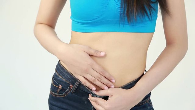 close up waist of woman in blue jeans