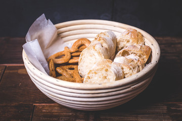 View of sliced baguette and crackers in a bowl.