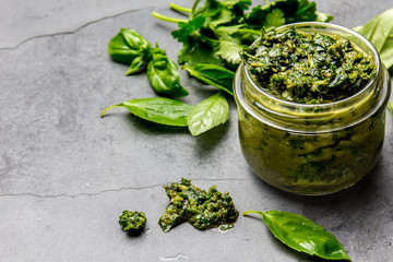Chimichurri sauce. Argentine green parsley basil sauce chimichurri for barbecue asado in glass jar,...