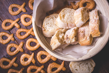 Top view of a sliced French baguette among cookies.