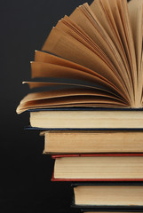 A Pile of Vintage Books on dark Blue Background. Vertical Image. Educational concept.