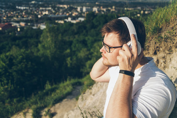 man listen music on the peak of the hill