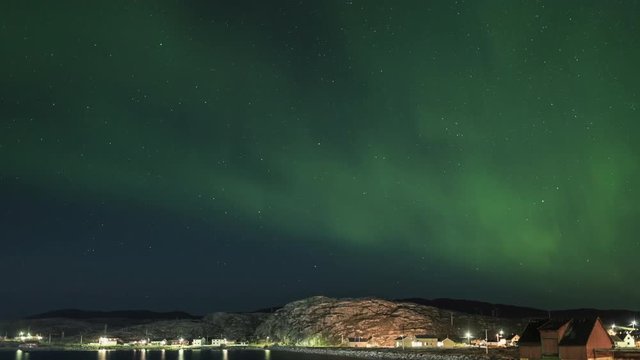 Tilt down timelapse, aurora borealis over pier in Norway