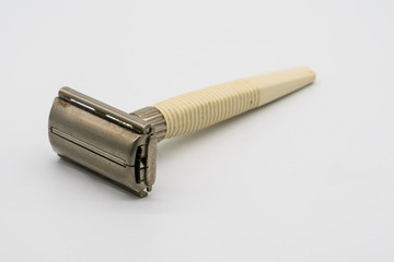 Vintage retro edged razor and shaver isolated on white
