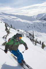 Fototapeta na wymiar Young man skiing in the mountains