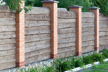Wooden fence with brick columns