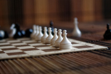 Wooden chess Board and plastic chess pieces, on board