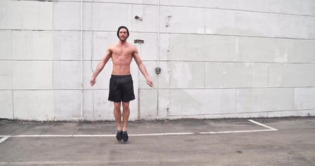 Athletic male working out in an empty parking lot. Crossfit. Slow Motion. - Powered by Adobe
