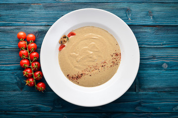 Mushroom puree soup. On a wooden background. Free space for your text. Top view.