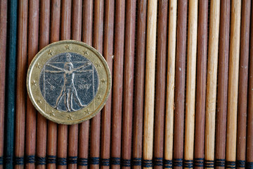 One euro coin lie on wooden bamboo table Denomination is 2 euro - back side