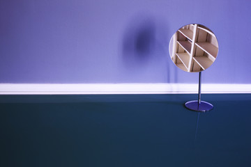 A reflection of empty shelves on a mirror on top of a table