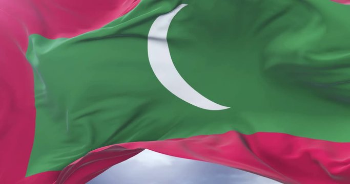 Maldivian flag waving at wind with blue sky in slow, loop