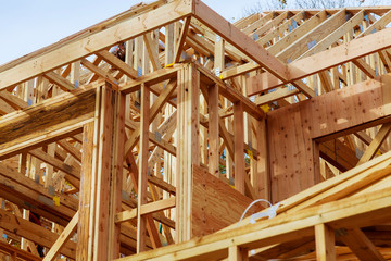 Close-up of gables roof on stick built home under construction New build roof with wooden truss, post and beam framework.