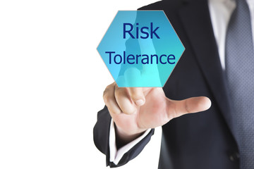 Businessman hand writing Risk Tolerance on a transparent wipe board