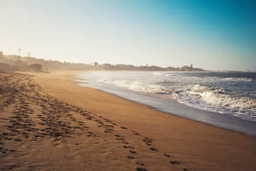 Scenic view of a beach and foot prints on the sand