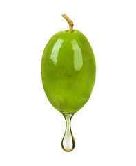 Obraz premium Green olive with a drop of oil close up on white background