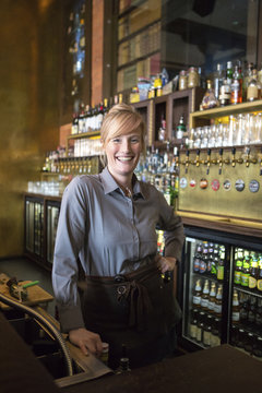 Portrait of happy female bartender