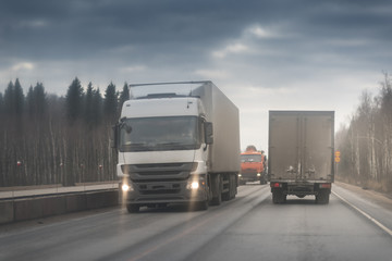 truck driving on the asphalt road in rural landscape. Winter time