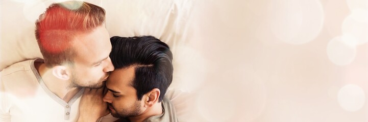 Happy gay couple lying on bed