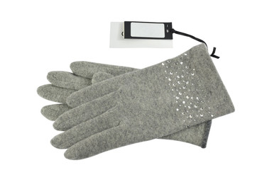 Pair of grey woolen gloves with a blank price tag beside it, on white background