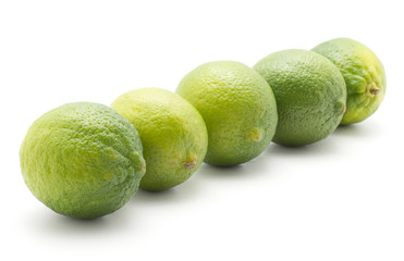 Five limes in row isolated on white background ripe and fresh.