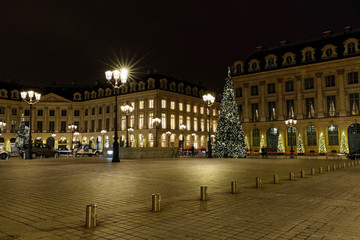 Fototapeta na wymiar Paris, France - December 17, 2017: Christmas trees and illumination at Place Vendome in Paris by night