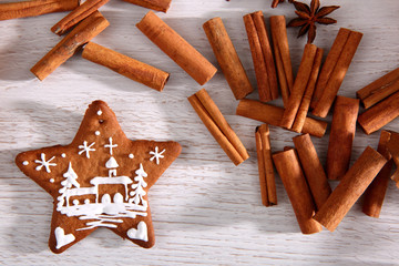 Gingerbread star poured white frosting on Christmas Eve table in a Christmas surprise for guests.
