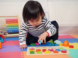 baby girl learning alphabet at home