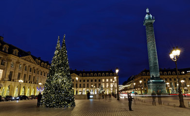 Fototapeta premium Paris, France - December 17, 2017: Christmas trees and illumination at Place Vendome in Paris by night