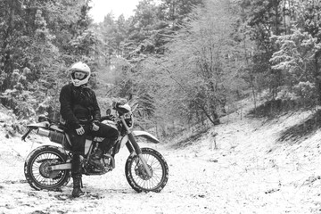 Fototapeta na wymiar Rider man on a motorcycle Winter motocross. Skid on a snowy forest. the snow from under the wheels of a motorcycle Enduro. off road dual sport travel tour, active life style concept